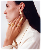 A model wearing EFEK gold cat rings from the Cats of Istanbul collection, photographed by Alessandro Oliva.