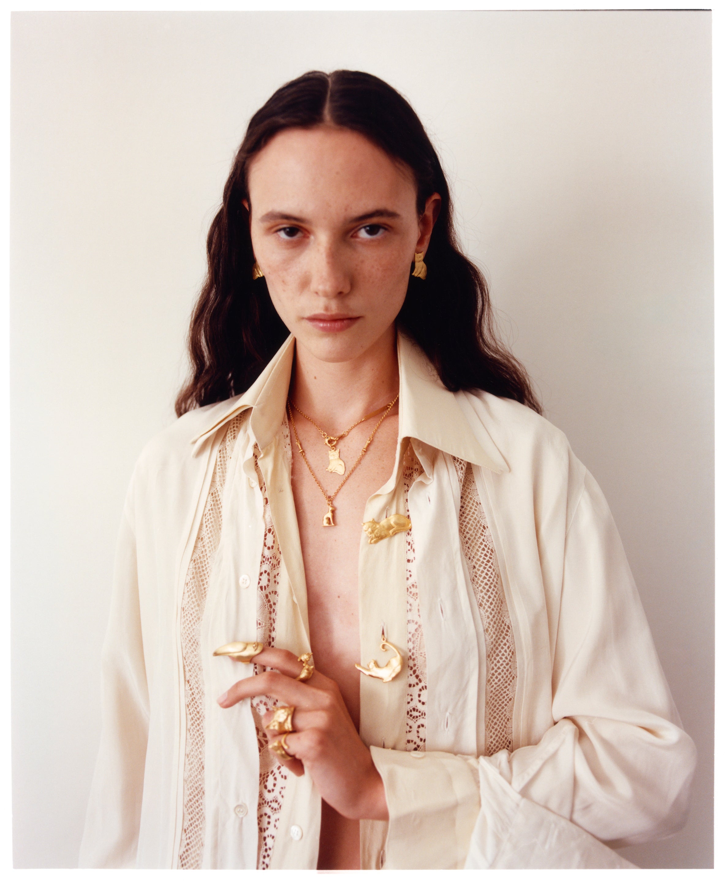 A portrait of a model wearing various jewelry from EFEK - Cats of Istanbul collection shot on film by Alessandro Oliva.