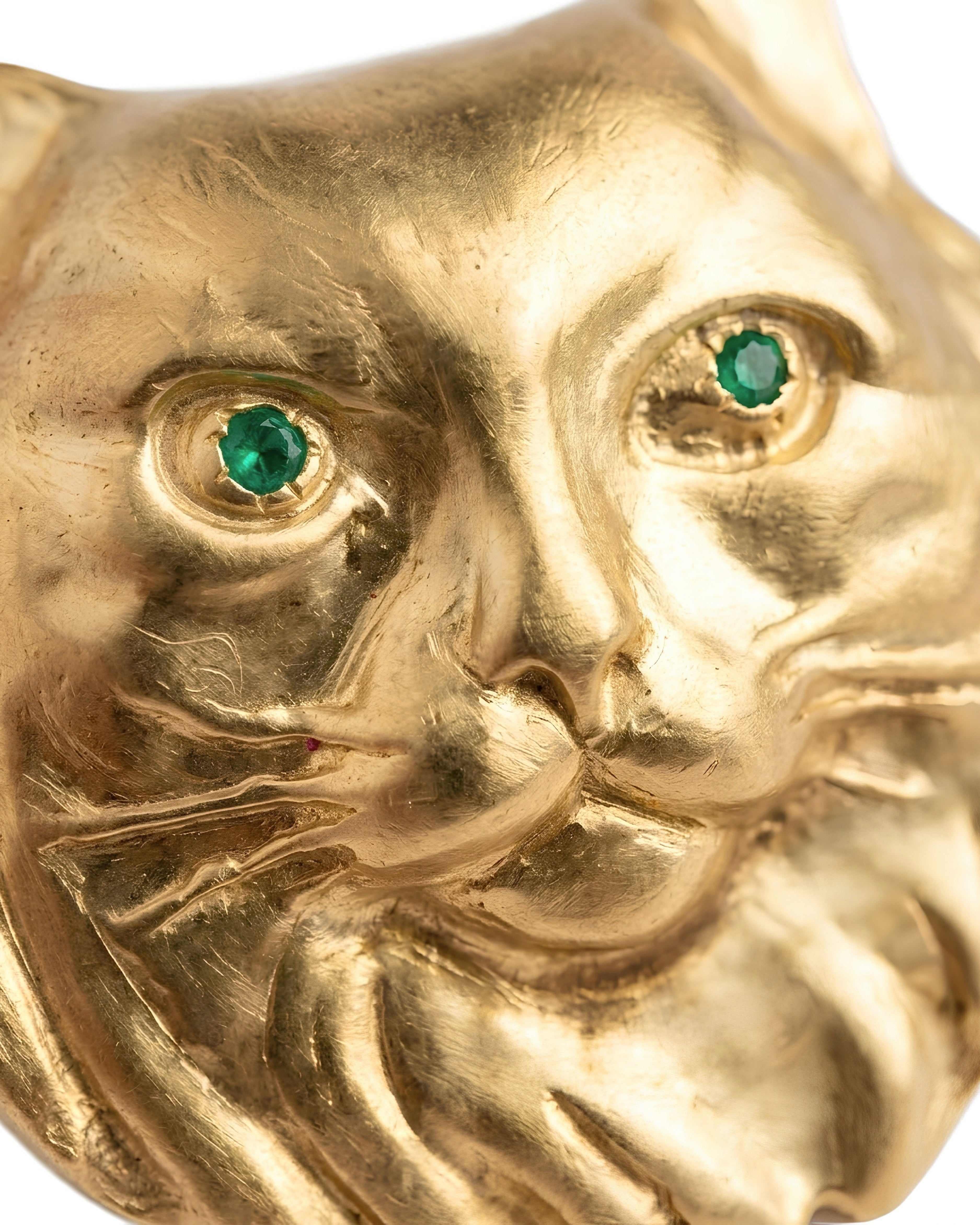Detail of PAŞA 18K gold-plated cat brooch with natural emerald eyes by EFEK
